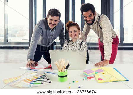 Business people in modern office posing for camera. Post processed with cross process filter.