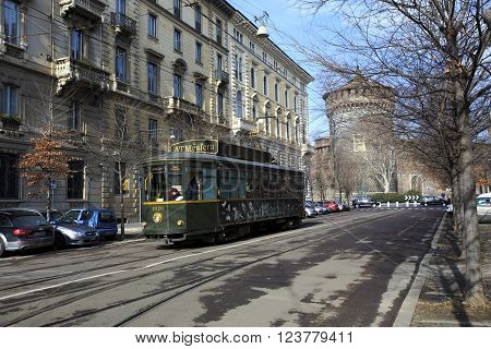 MILAN ITALY - FEBRUARY 08 2010 Old traditional tram ATM on the street of Milan used as moving restaurant ATMOSFERA on February 8 2015. Milan tramway network operation since 1881.