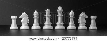 White chess figures isolated on the black background. Set of chess figures.