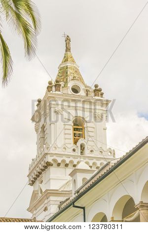 Low angle view of one of the towers of the ancient San Franciso catholic church located in the historic center of Quito in Ecuador.