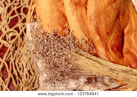 Several Armenian homemade mantakash bread in a basket. Colorful photo.