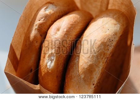Several armenian homemade bread mantakash in a paper bag. Colorful photo.