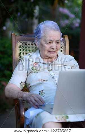 Grandma using and talking on a laptop