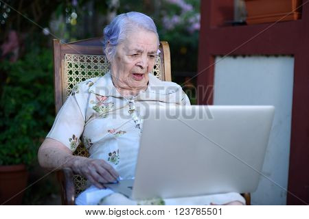 Grandma concentrated and working on a laptop