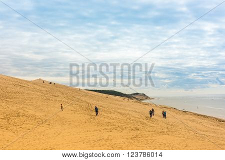 People Visiting The Highest Sand Dune Of Pyla In Europe
