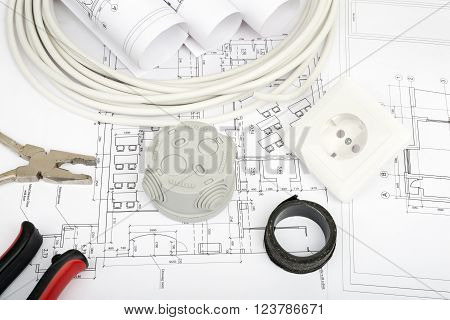 Architecture plan and rolls of blueprints with cabel and plug. Building concept