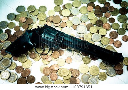 Picture of a Business Money Concept Idea Coins and Gun