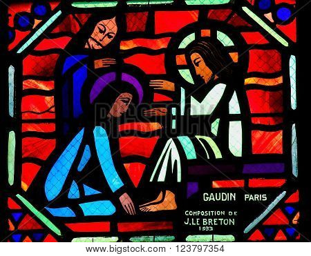 AMIENS, FRANCE - FEBRUARY 9, 2013: Stained glass window depicting Jesus washing the feet of the apostle Peter at the Last Supper on Maundy Thursday, in the Cathedral of Our Lady of Amiens, France.