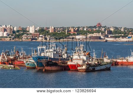 Montevideo Uruguay - December 15 2012: The abandoned old rusty ship in the Port of Montevideo Uruguay at December 15 2012. Montevideo in the background.