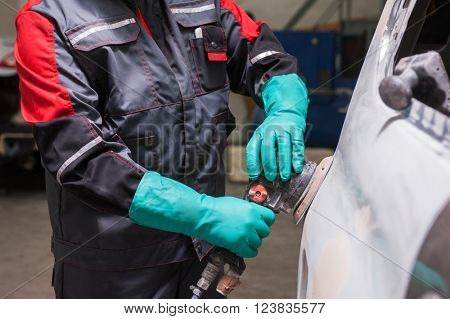 Polishing the car with power buffer machine , closeup