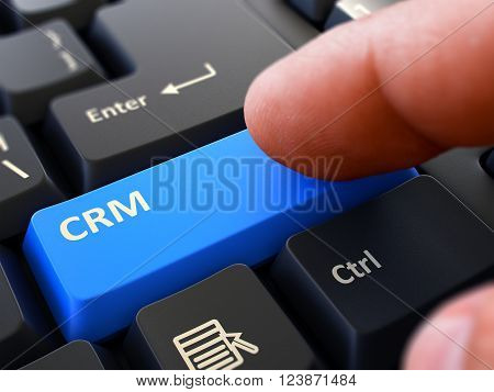 Computer User Presses Blue Button CRM - Customer Relationship Management - on Black Keyboard. Closeup View. Blurred Background. 3D Render.