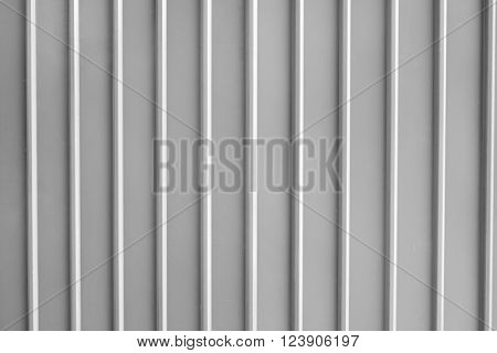 Seamless abstract background grey silver aluminium metal plate texture with vertical lines pattern.