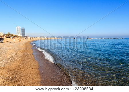 Barcelona, Spain - November 11, 2015: Beach in Barceloneta and Mediterranean Sea. La Barceloneta is a neighborhood in the Ciutat Vella district of Barcelona. It is known for its sandy beach.