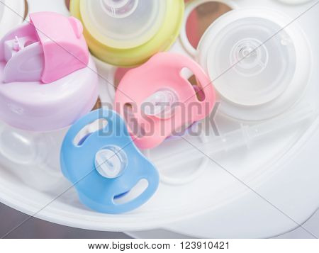 Steam sterilizer and dryer for sterilize baby accessories. Nipple teethers and milk bottles in steam sterilizer and dryer. Steam sterilizer used for sterilize baby accessories by high temperature steam.