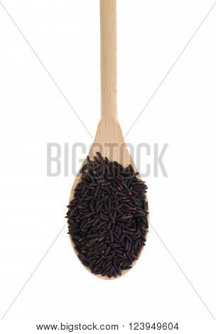 Heap of black rice a range of rice types of the species Oryza sativa L. which is high in nutritional value and is a source of iron vitamin E and antioxidants in a wooden spoon.