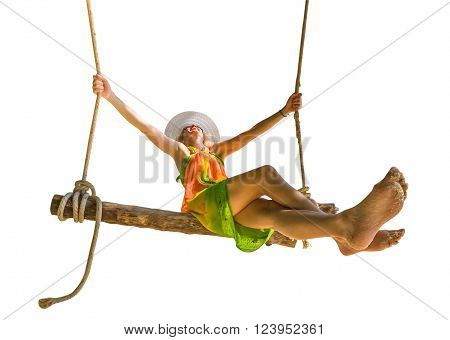 Happy and attractive woman with colorful sarong and white wide-brimmed hat swinging.  Isolated on white background.