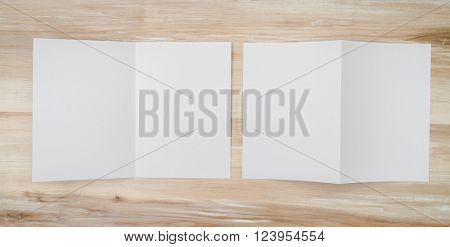 Bifold white template paper on wood texture