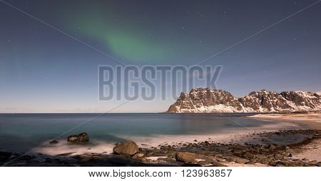 Northern lights over the sea at Utakleiv Beach Lofoten Islands Norway in the winter.