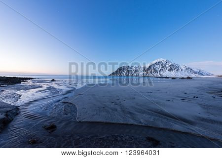 Skagsanden Beach in the Lofoten Islands Norway in the winter at dusk.