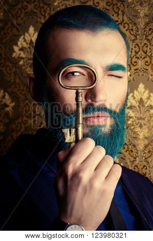 Vintage portrait of a handsome man with blue beard. 