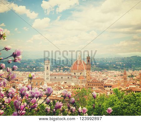 cityscape with church Santa Maria del Fiore at spring day with blooming magnolia, Florence, Italy, retro toned