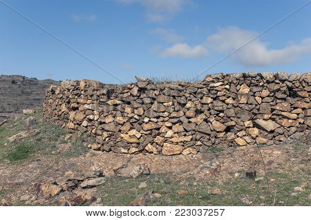 Old stones rocky wall weathered by time