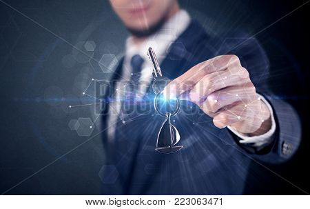 Businessman in suit holding over a key with connection concept around
