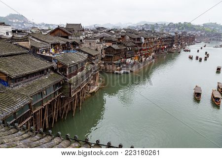 Old Houses on the river in Fenghuang Ancient town, Hunan province, China. This ancient town was added to the UNESCO World Heritage Tentative List in the Cultural category.