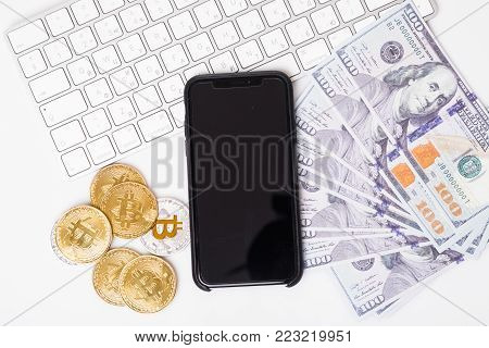Phone With Bitcions And Dollar Cash Near Keyboard Isolated On White Background