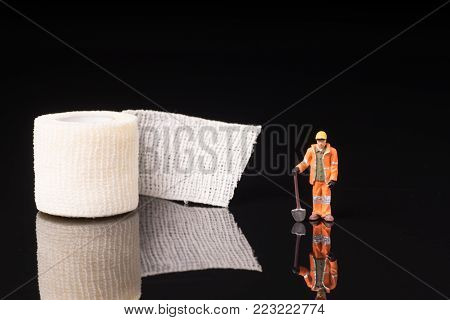 Bandage used for injuries during work, leisure time or in housework, isolated on glossy black background