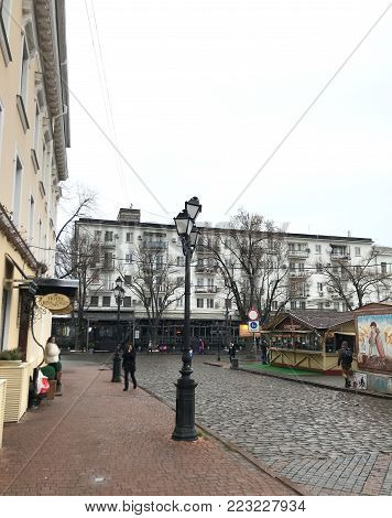Odessa, Ukraine - December 28, 2017: People visit Deribasovskaya Street. Deribasovskaya is the central street of Odessa and one of the main attractions of the city.