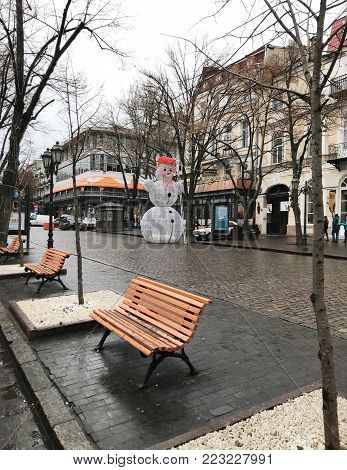 Odessa, Ukraine - December 28, 2017: People visit Deribasovskaya Street. Deribasovskaya is the central street of Odessa and one of the main attractions of the city.