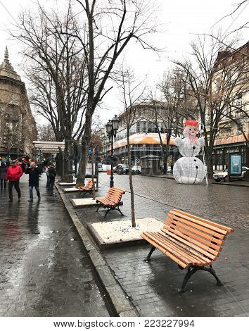 Odessa, Ukraine - December 28, 2017: People visit Deribasovskaya Street. Deribasovskaya is the central street of Odessa and one of the main attractions of the city.