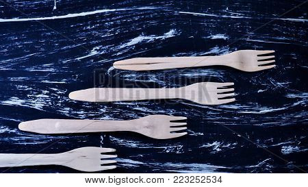 Silver fork lying on a wooden table.