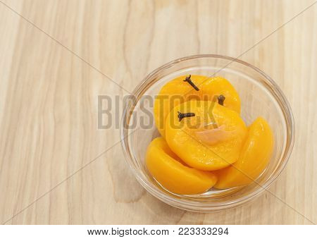 Homemade Peach Compote Spiced With Cloves In A Glass Bowl On A Wooden Background