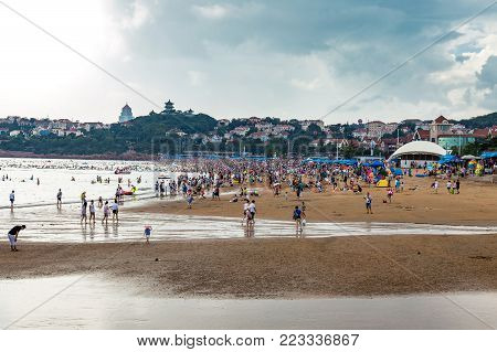 06-08-2016 - Qingdao, China - famous beach N1 crowded with chinese tourists visiting the city of Qingdao in August, during the beer festival period