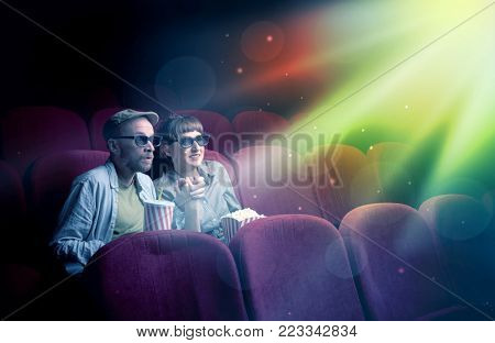 Teenager couple cuddling and watching the climax part of the movie