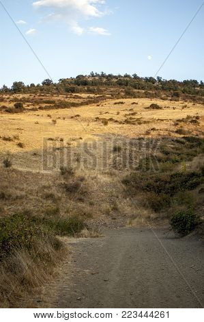 Rural road next to the slope of the mountain