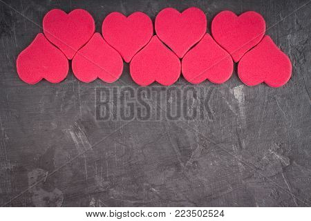 Pink hearts on a gray background. The symbol of the day of lovers. Valentine's Day. Concept February 14