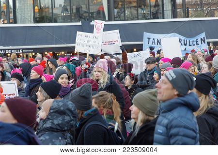 STOCKHOLM, SWEDEN - JAN 21, 2018: Young women holding a placard in the Womens March, a worldwide protest for women's rights in central Stockholm, Norrmalmstorg, Sweden, January 21, 2018