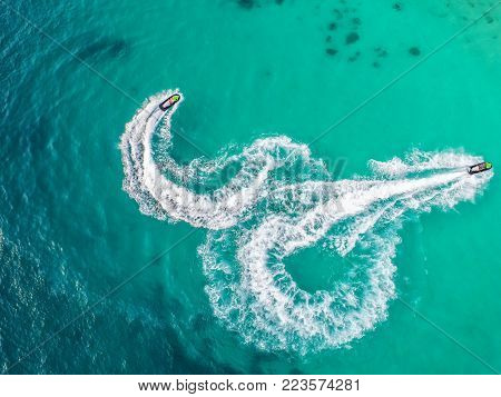 People are playing a jet ski in the sea.Aerial view. Top view.amazing nature background.The color of the water and beautifully bright. Fresh freedom. Adventure day.clear turquoise at tropical beach.