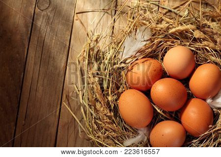 Hen Organic Eggs In The Nest. On Wooden Rustic Background.copy Space