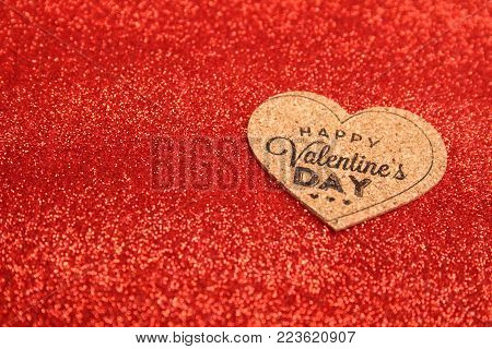 Red glistening background, the redditch with the text of the happy St. Valentine's Day
