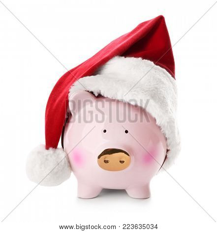 Piggy bank with Santa hat on white background
