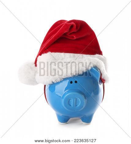 Piggy bank with Santa hat on white background
