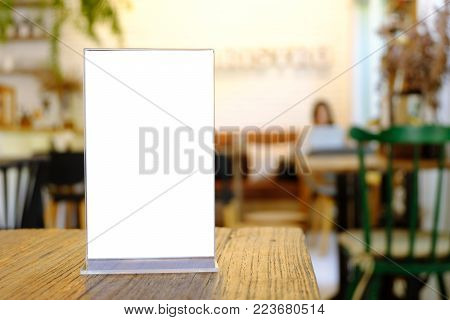 Mock Up Menu Frame Standing On Wood Table In Bar Restaurant Cafe. Space For Text