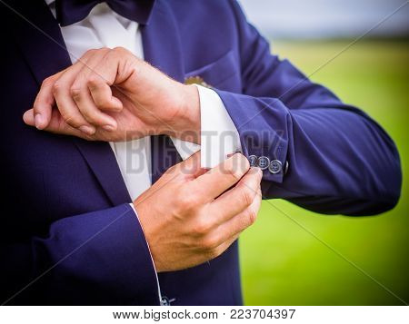 Thr posed groom with button hole.Wedding details, beautiful boutonniere