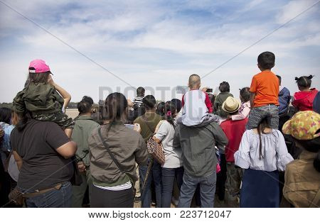 back of kid on parent shoulder  for kid see
