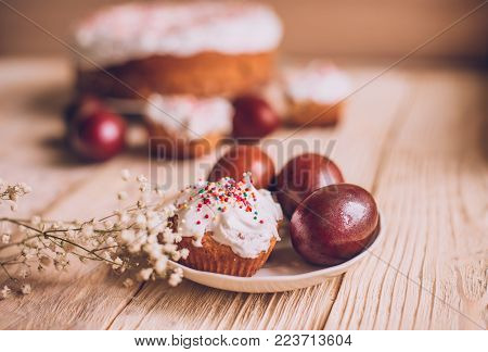 Easter Table With Traditional Easter Cakes And Easter Eggs With Blossoming Tree Branch