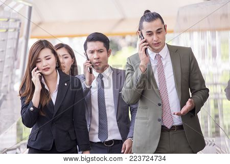 Businesspeople Using Smartphone For Talk Business Project While Walking. Businesspeople  Working Con